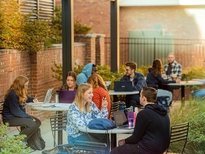 students sitting outside studying